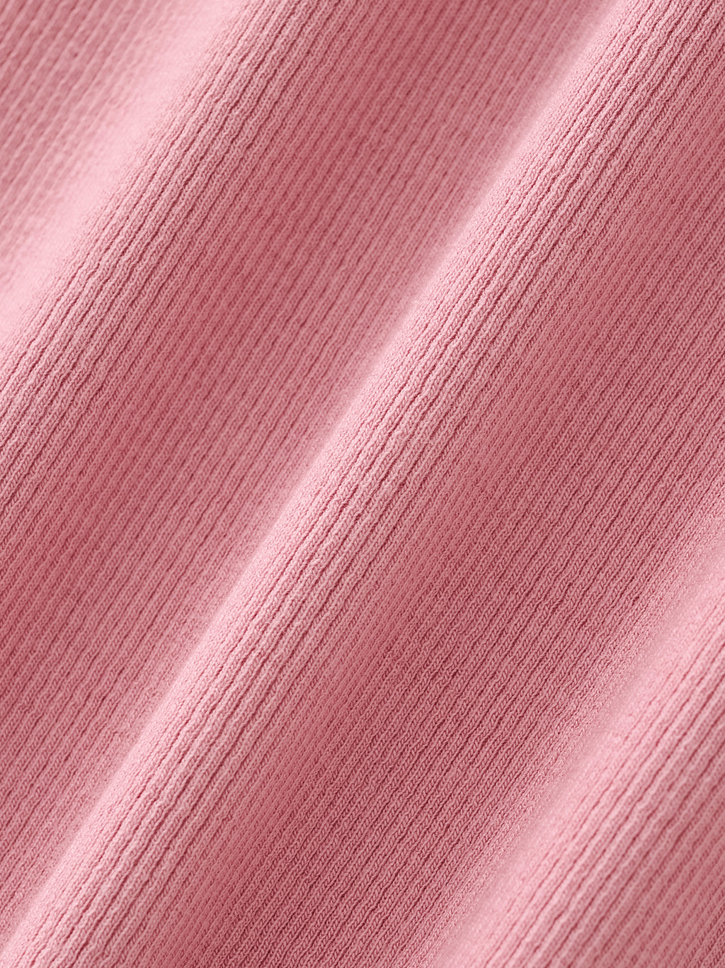 Close-up of pink ribbed athletic fabric texture, soft and breathable performance material