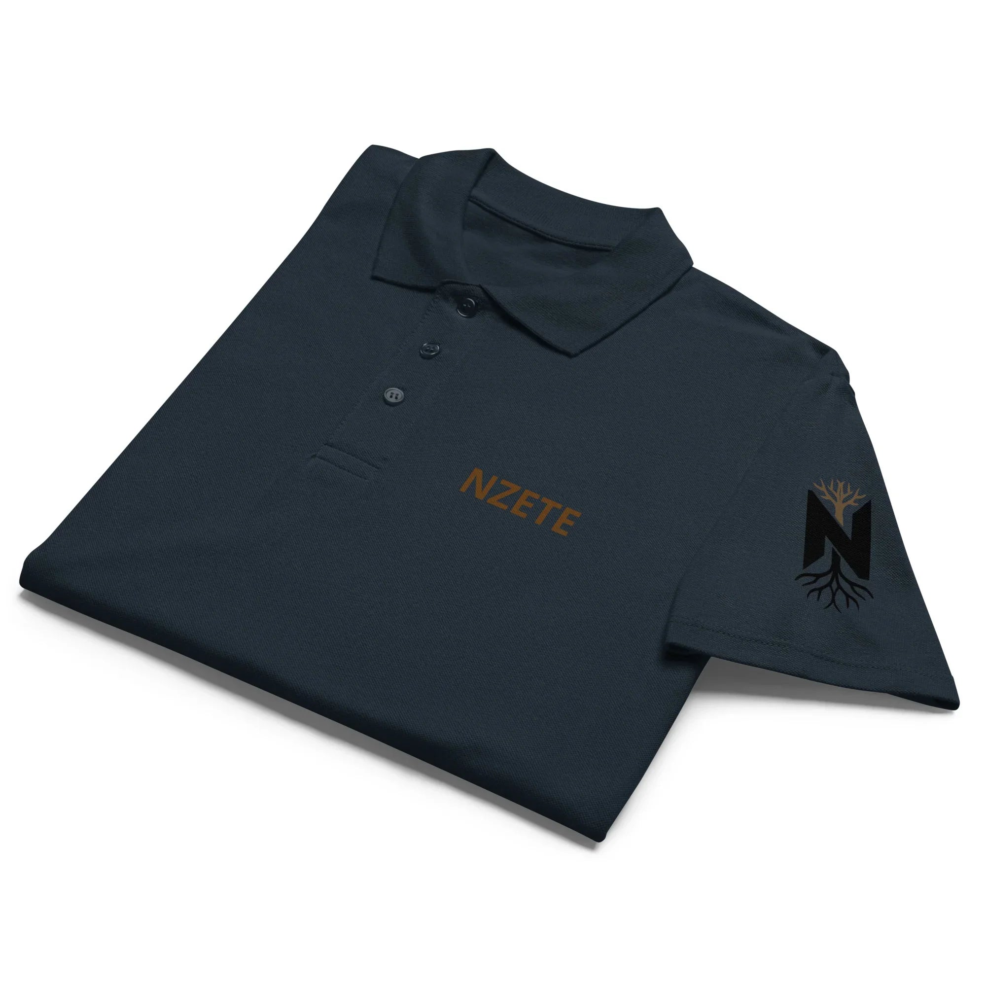 Folded navy blue unisex premium pique polo shirt with tree logo on sleeve and NZETE text on chest